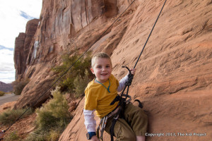 boy rock climbing in Moab UT