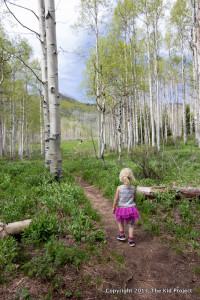 girl tutu hiking through aspens