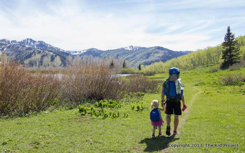 Family backpacking in meadow