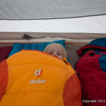 Girl in Deuter Sleeping Bag, in tent