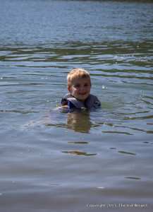 boy in lifejacket swimming