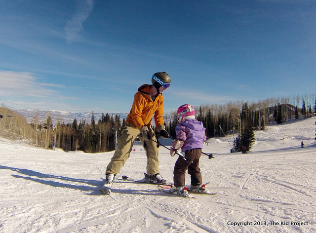 Dad skiing with toddler at Canyons Resort, Utah