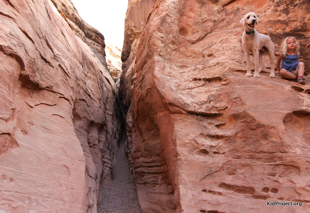 Kai is nothing but smiles on this adventure, overlooking the next section of narrow slot canyon.