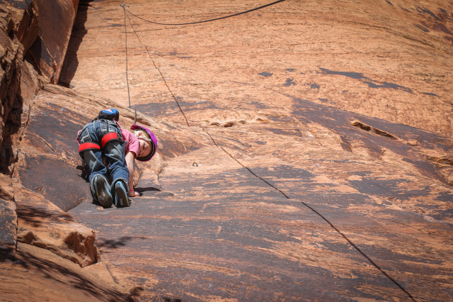 Girl climbing Seibernetics near Moab, UT