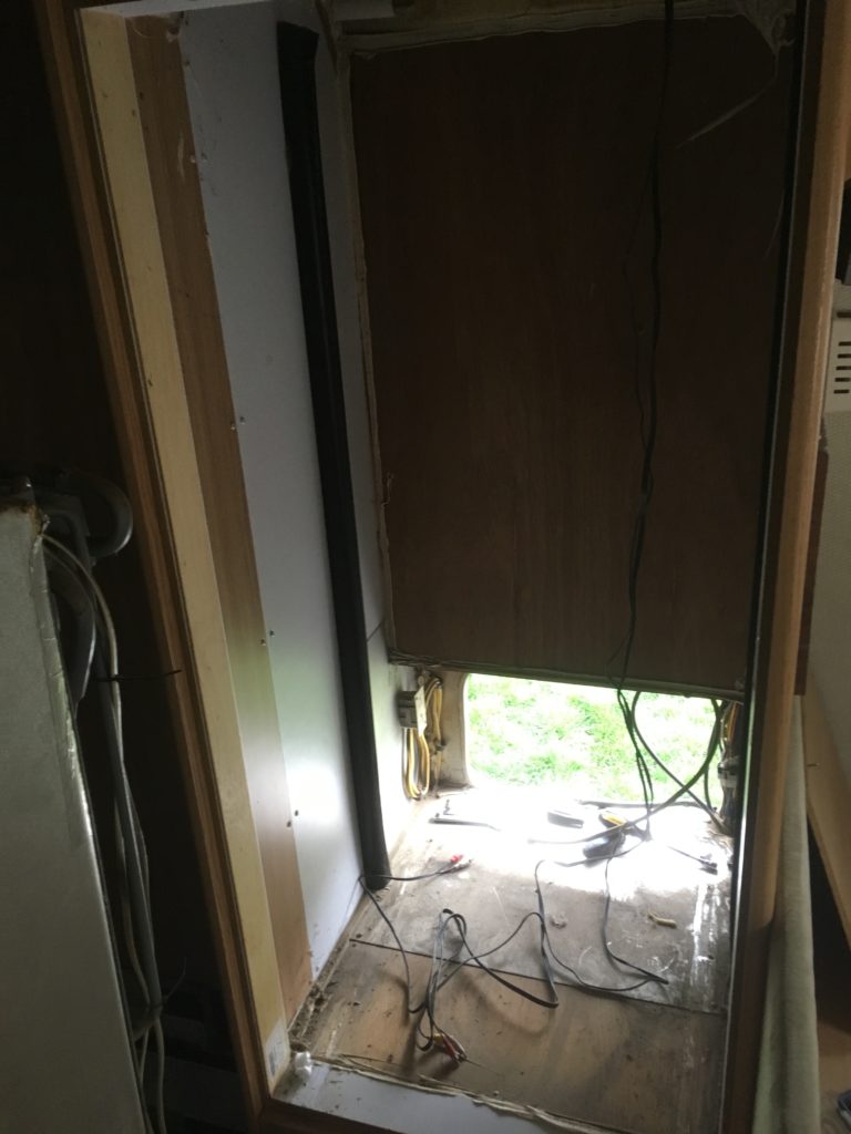 Behind the refrigerator with it removed