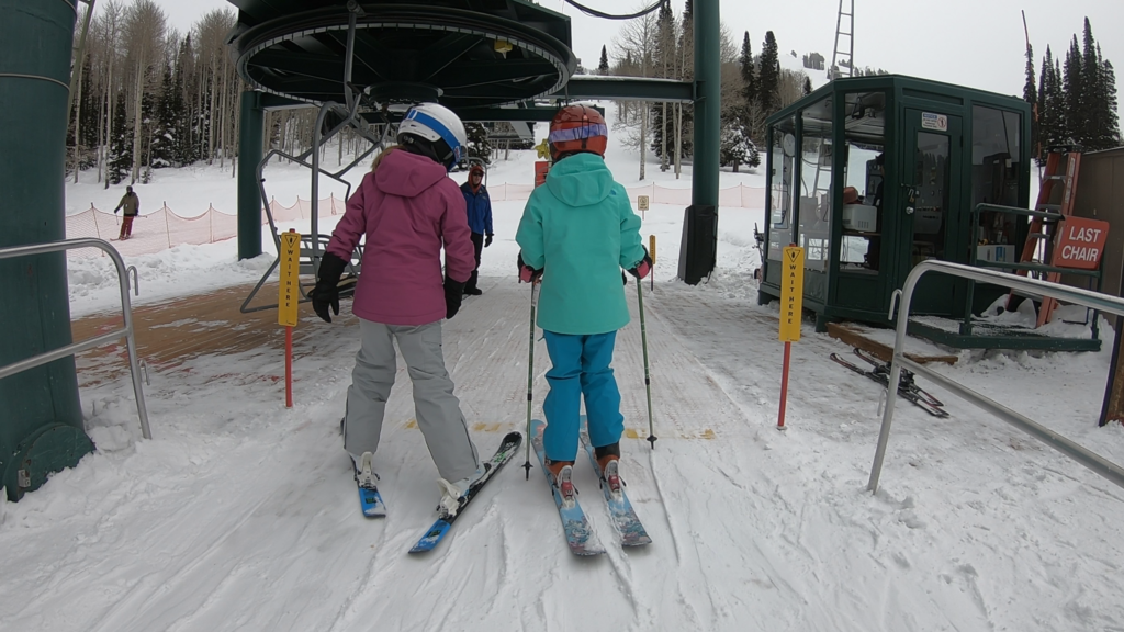 kids ski with friend